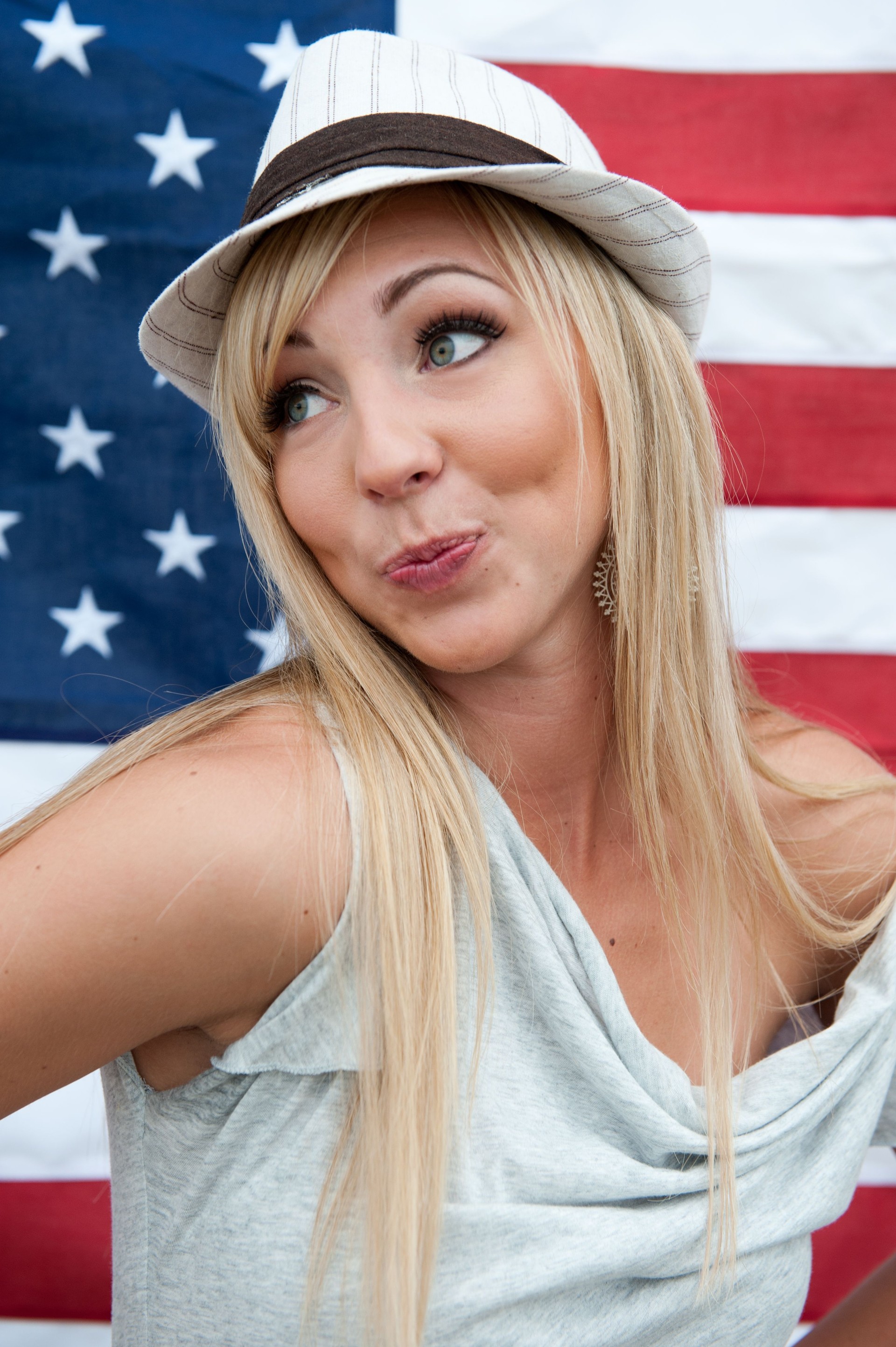 Beautiful young woman in front of an american flag